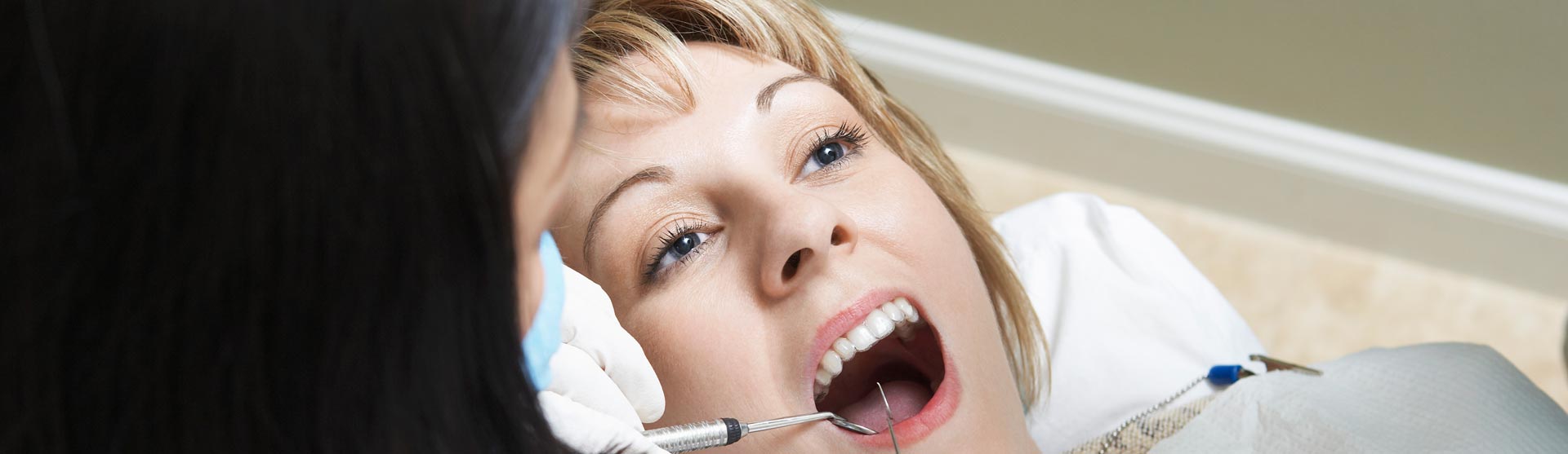 Dentist examining patient's invisalign braces