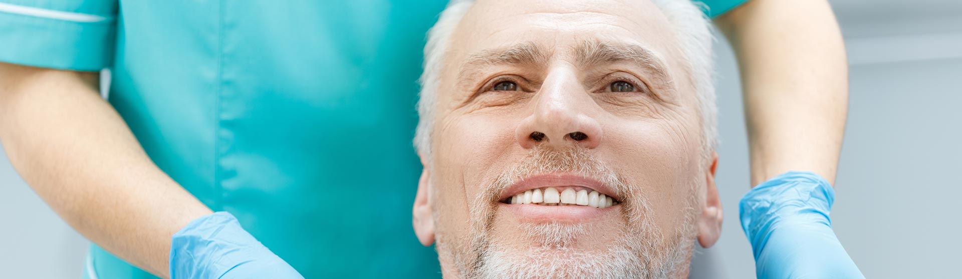 Happy middle aged man after having dental implants treatment